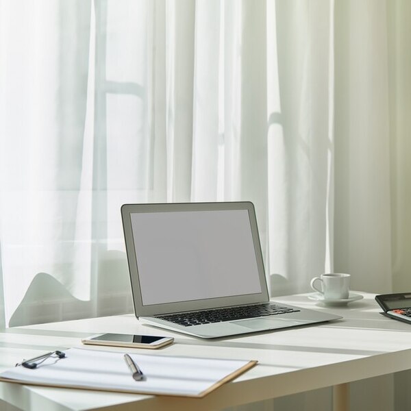A clean desk with a notebook and soft natural light